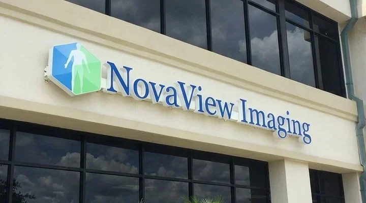 illuminated led channel letters and 3d logo sign for medical imaging facility novaview imaging storefront sign with blue 3d letters on a commercial wall 4